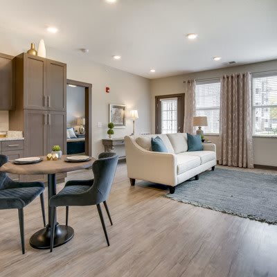 A modern open-concept living and dining area with stylish furniture and wood flooring.