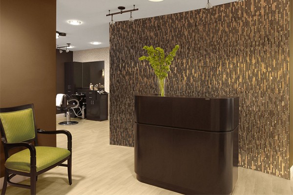 A modern salon reception area with elegant decor and furniture.