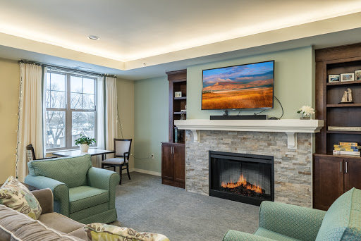 A cozy and modern living room featuring a fireplace and a mounted television.