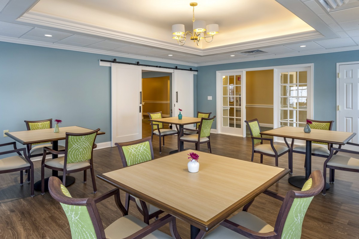 A modern dining room with neatly arranged tables and chairs in a well-lit interior.