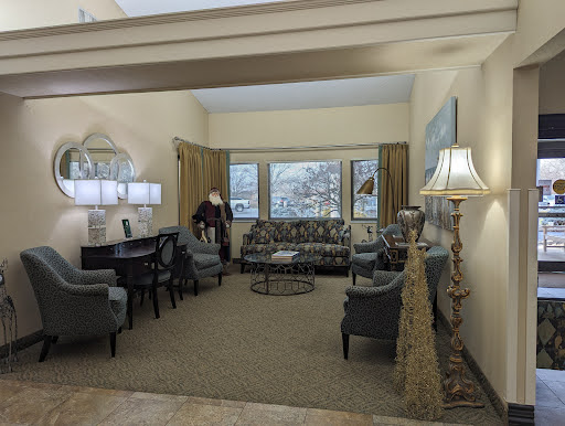 A cozy and elegantly designed living room featuring comfortable seating and a pleasant window view.