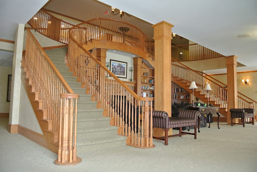 A beautifully designed hotel lobby featuring a wooden staircase and comfortable seating.
