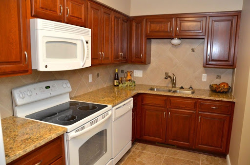 A modern kitchen showcasing wooden cabinets and essential appliances.