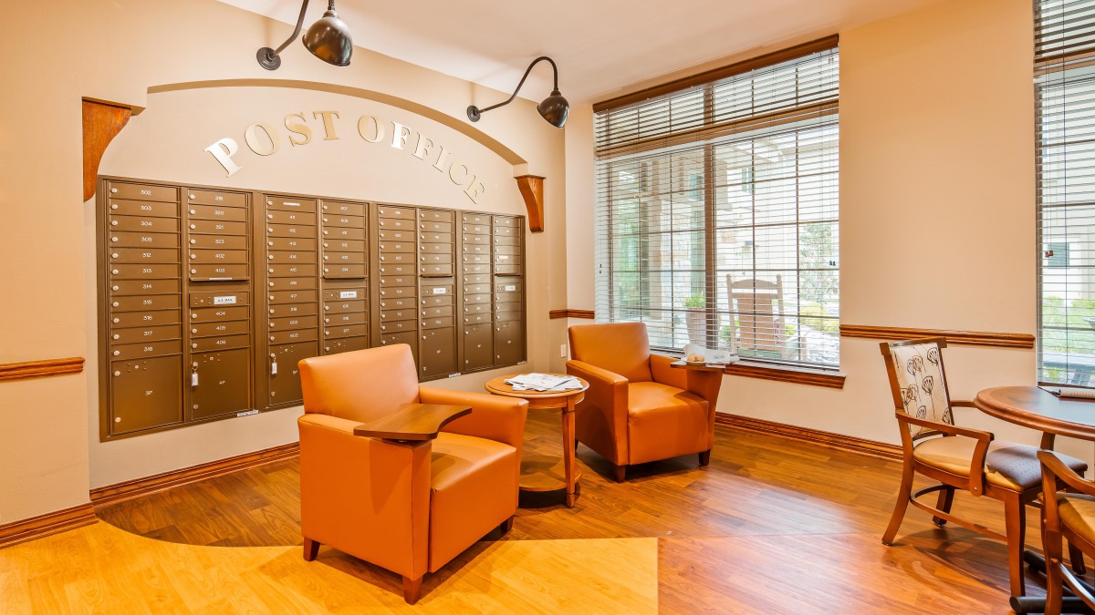 A cozy mailroom with comfortable seating and ample natural light.