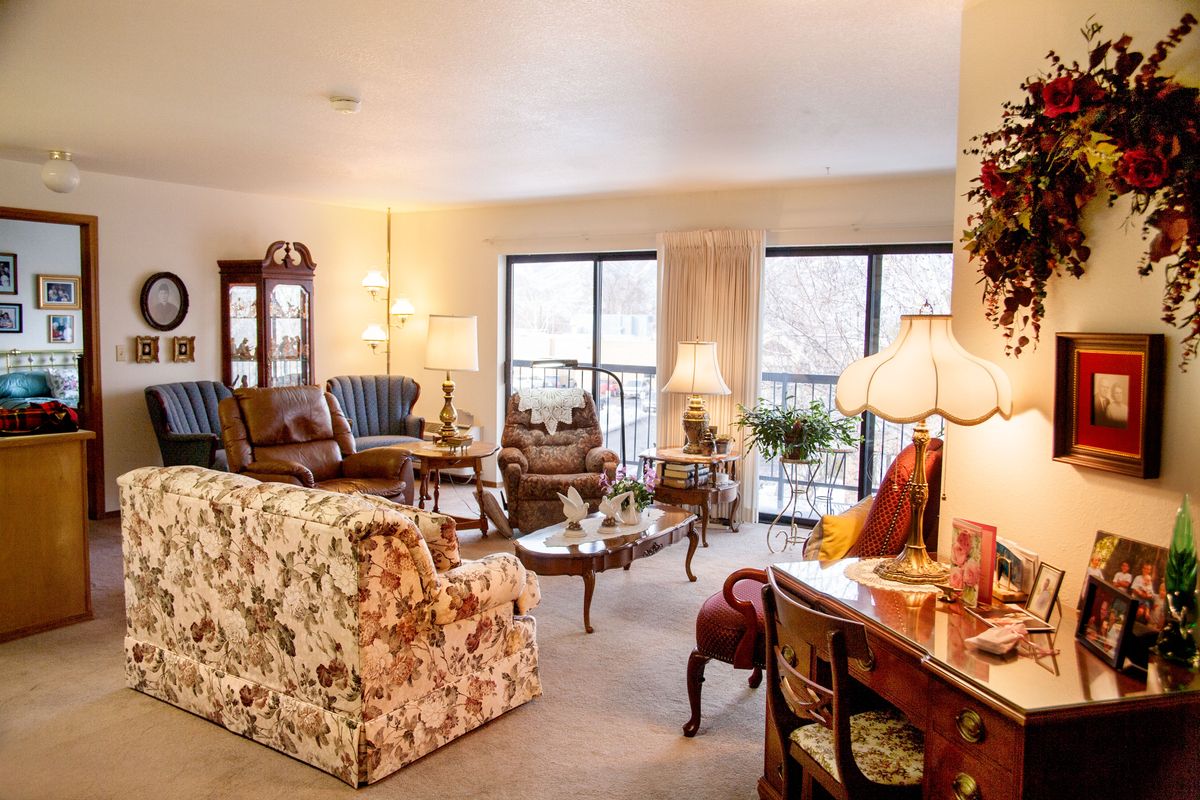 A cozy vintage-style living room with floral patterns and elegant furnishings.