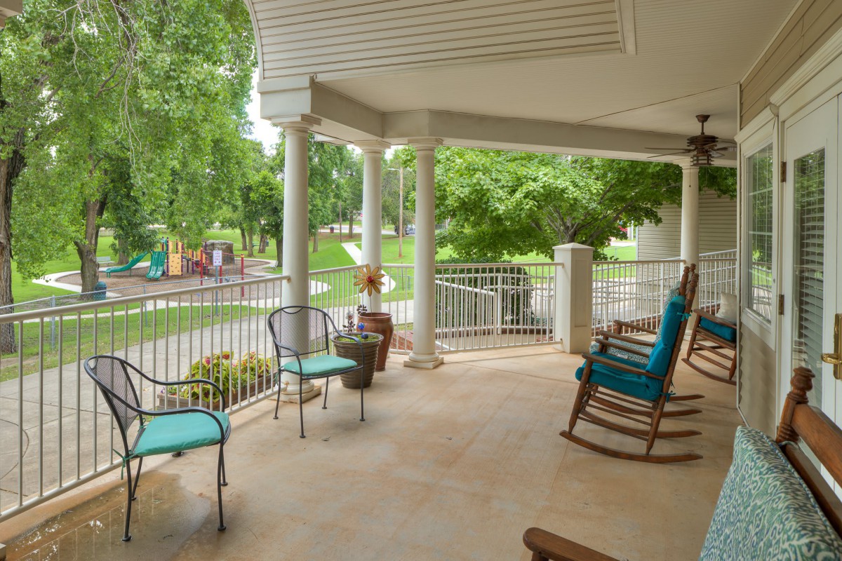 A cozy porch with rocking chairs and a view of the garden.