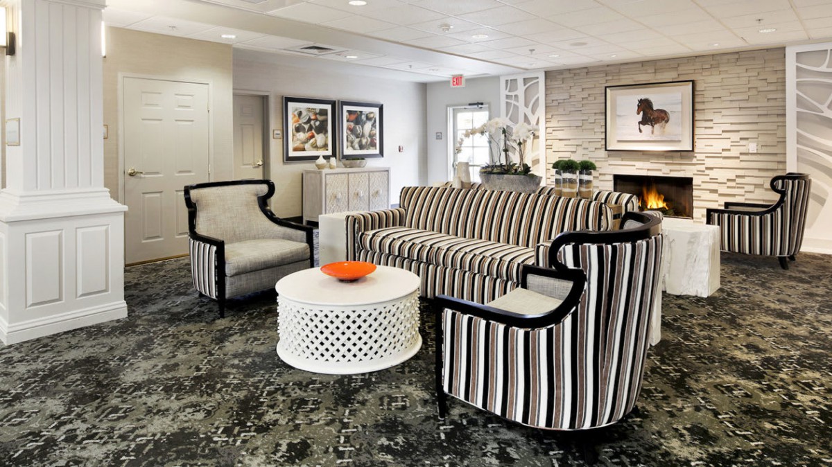 A stylish living room with striped furniture and modern decor.