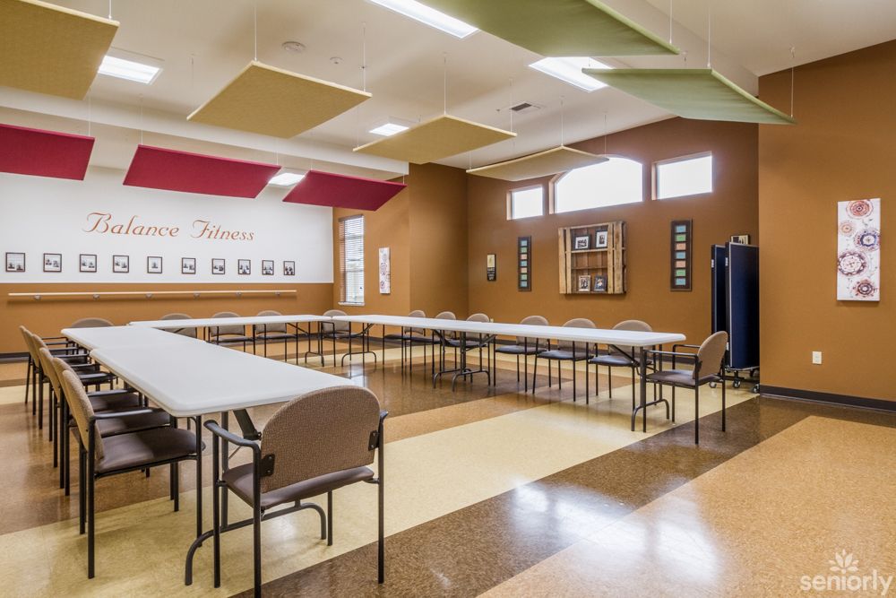 An empty conference room with arranged tables and chairs, ready for a meeting.