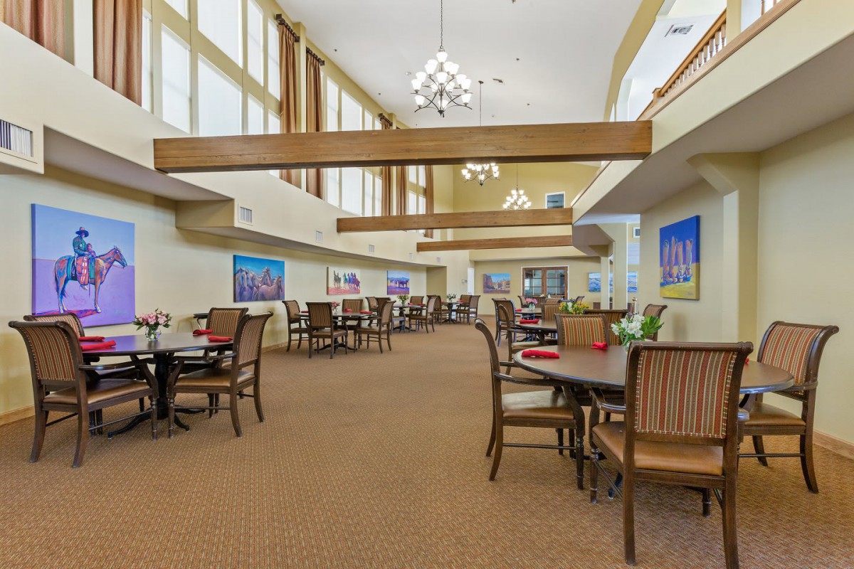 A spacious and well-lit dining area with tables and chairs arranged neatly.