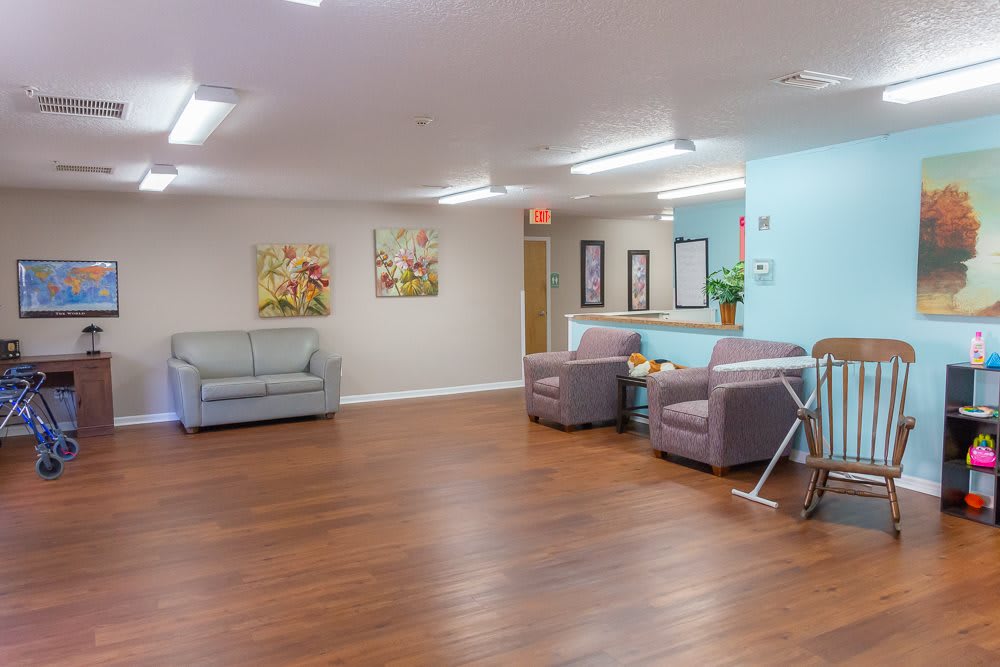 A spacious waiting room with comfortable seating and decorative wall art.