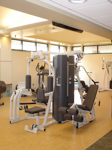 A well-equipped gym featuring various fitness machines for strength training.