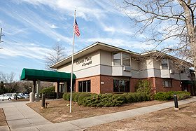 Exterior view of a hospital building with an American flag.