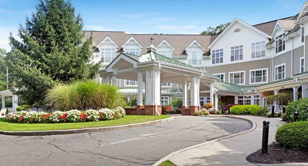 A modern building with a grand entrance and well-maintained landscaping.