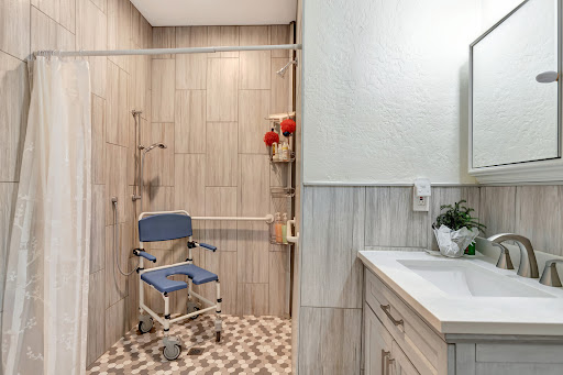 A modern, accessible bathroom featuring a shower with safety features and mobility aids.