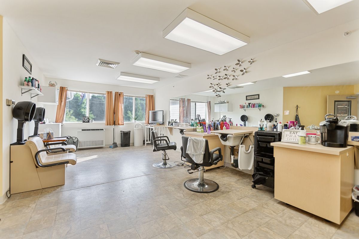 An empty salon with styling stations and equipment ready for clients.