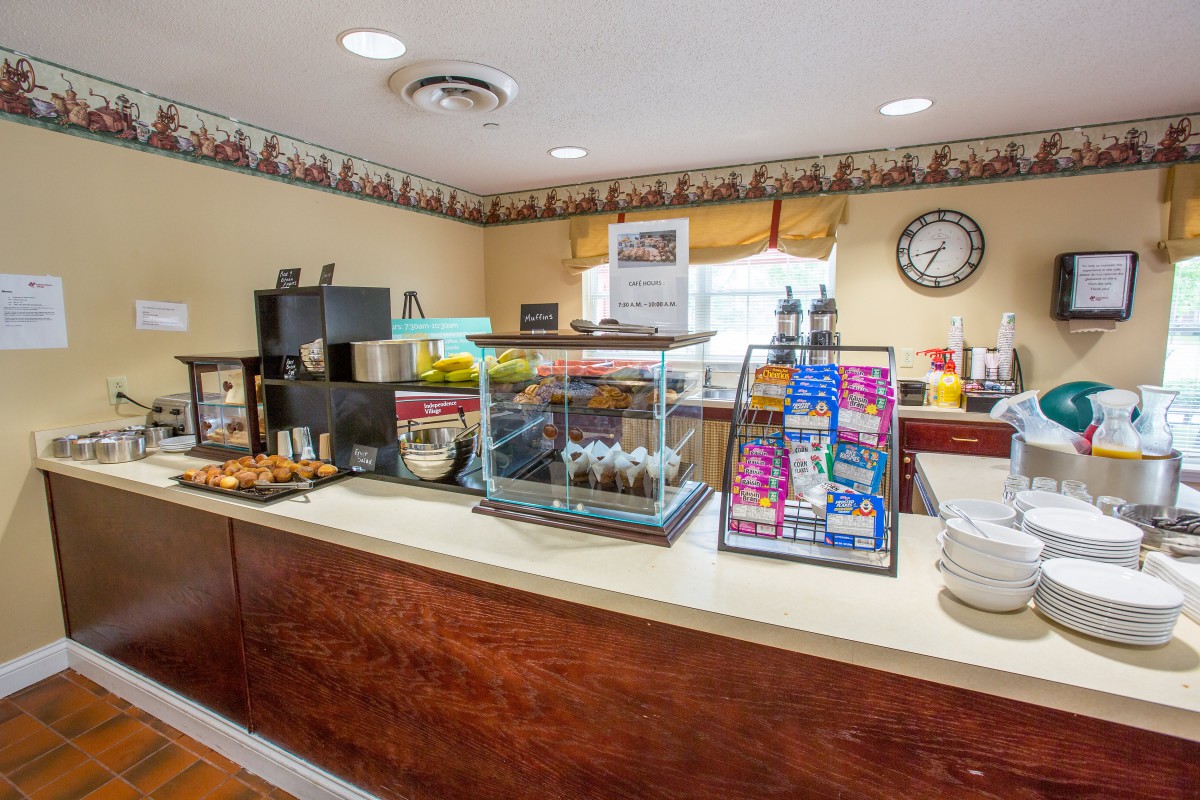 A cozy breakfast area featuring a buffet with various food and drink options.