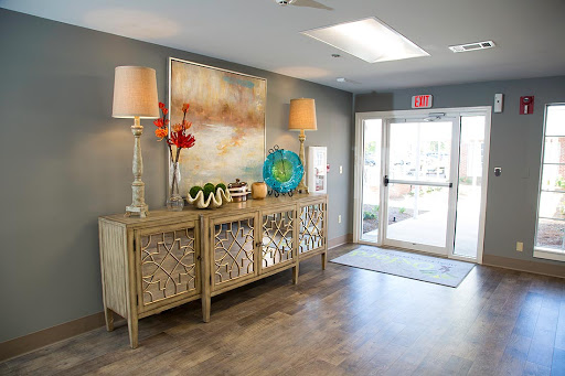 A beautifully decorated lobby featuring stylish furniture, art, and ample natural light.