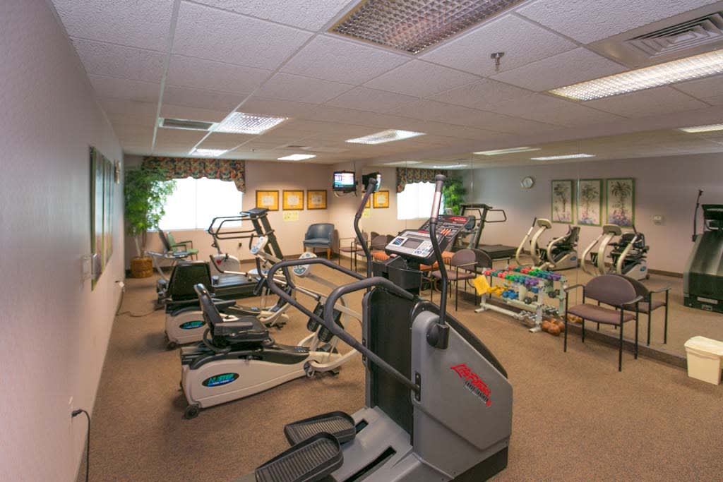 A gym equipped with various exercise machines and fitness equipment.