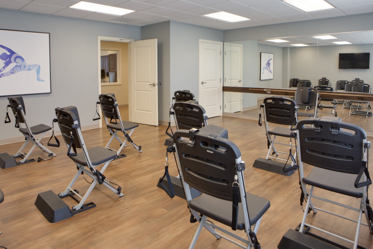 A modern conference room setup with folding chairs arranged for a meeting or presentation.