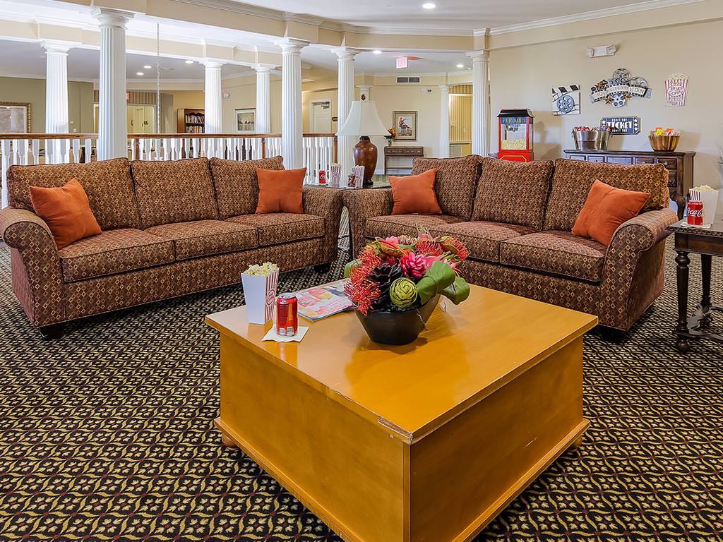 A cozy living room with patterned sofas and a wooden coffee table.