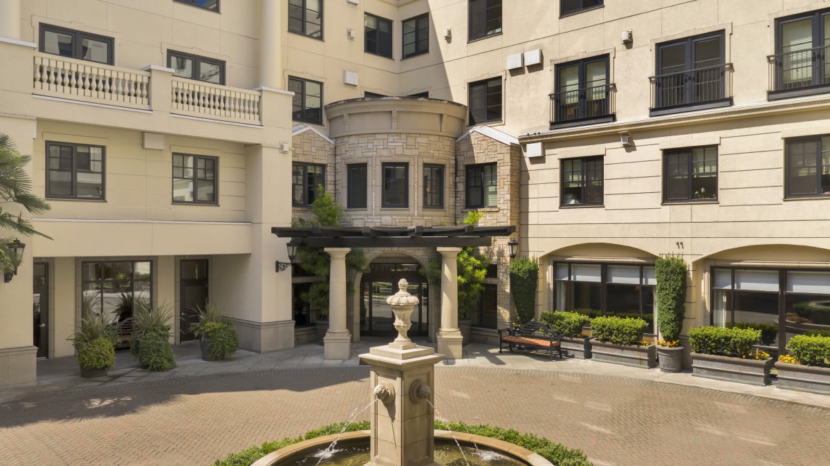 A stylish residential building with a courtyard and fountain.