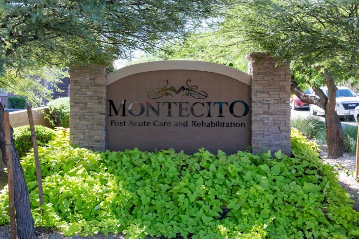 Entrance sign for Montecito Post Acute Care and Rehabilitation surrounded by lush greenery.