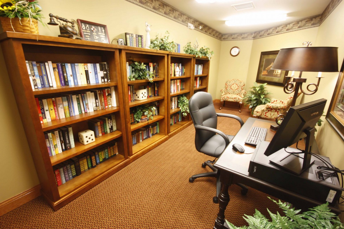 A well-organized office with bookshelves, a desk, and a chair.