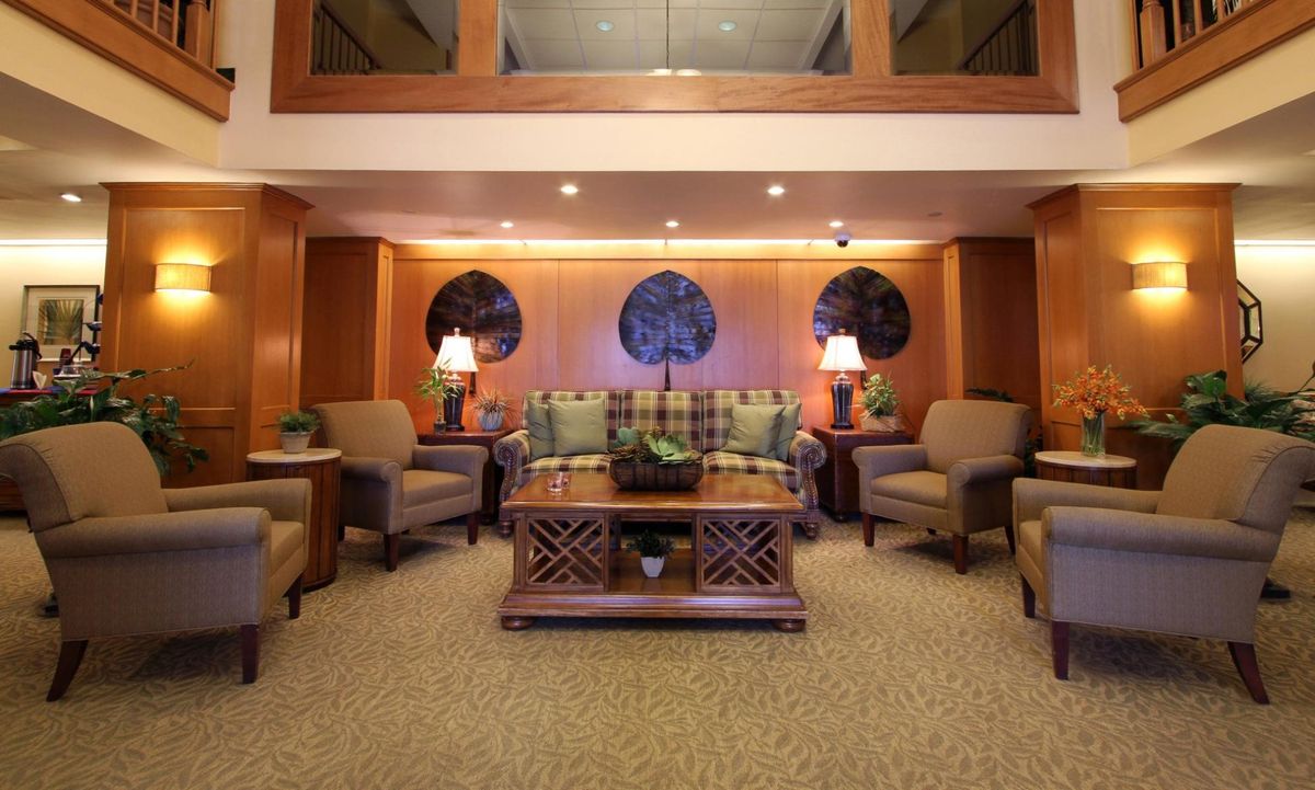 A cozy living room with comfortable seating and warm lighting.