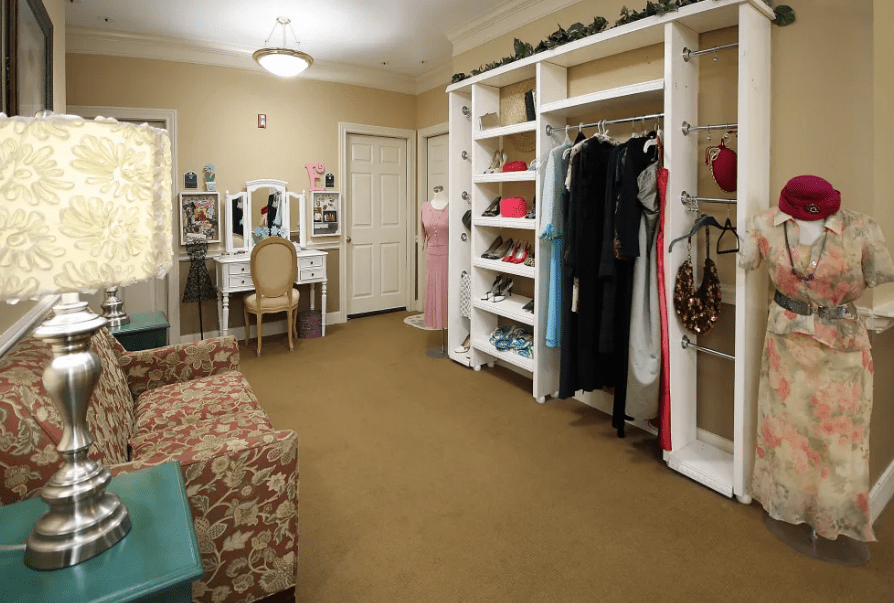 A well-organized walk-in closet with various clothing items and accessories neatly arranged.