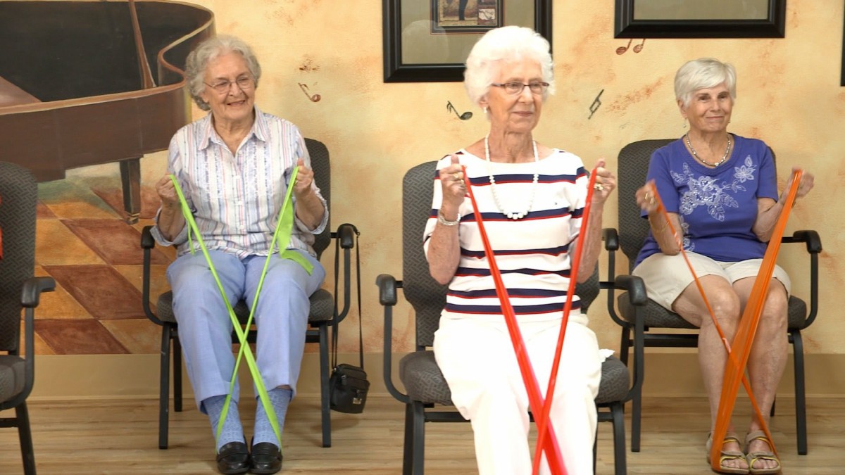 Seniors engaging in a group exercise session using resistance bands.