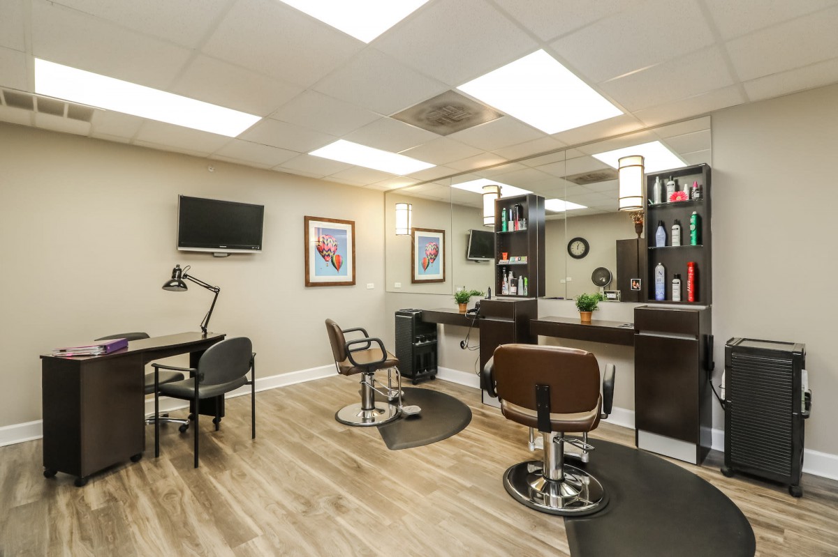 Modern hair salon interior with styling stations and a cozy atmosphere.