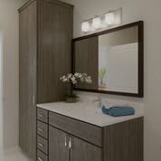 A modern bathroom vanity with a large mirror and cabinet storage.