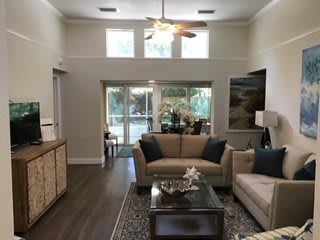 A modern living room with cozy sofas, a coffee table, and ample natural light.