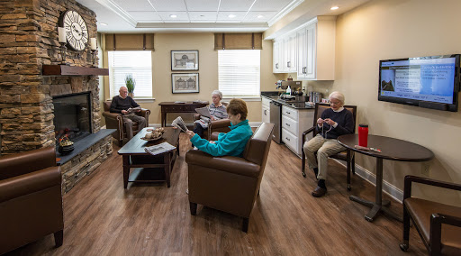 A cozy common room where senior citizens engage in leisure activities.