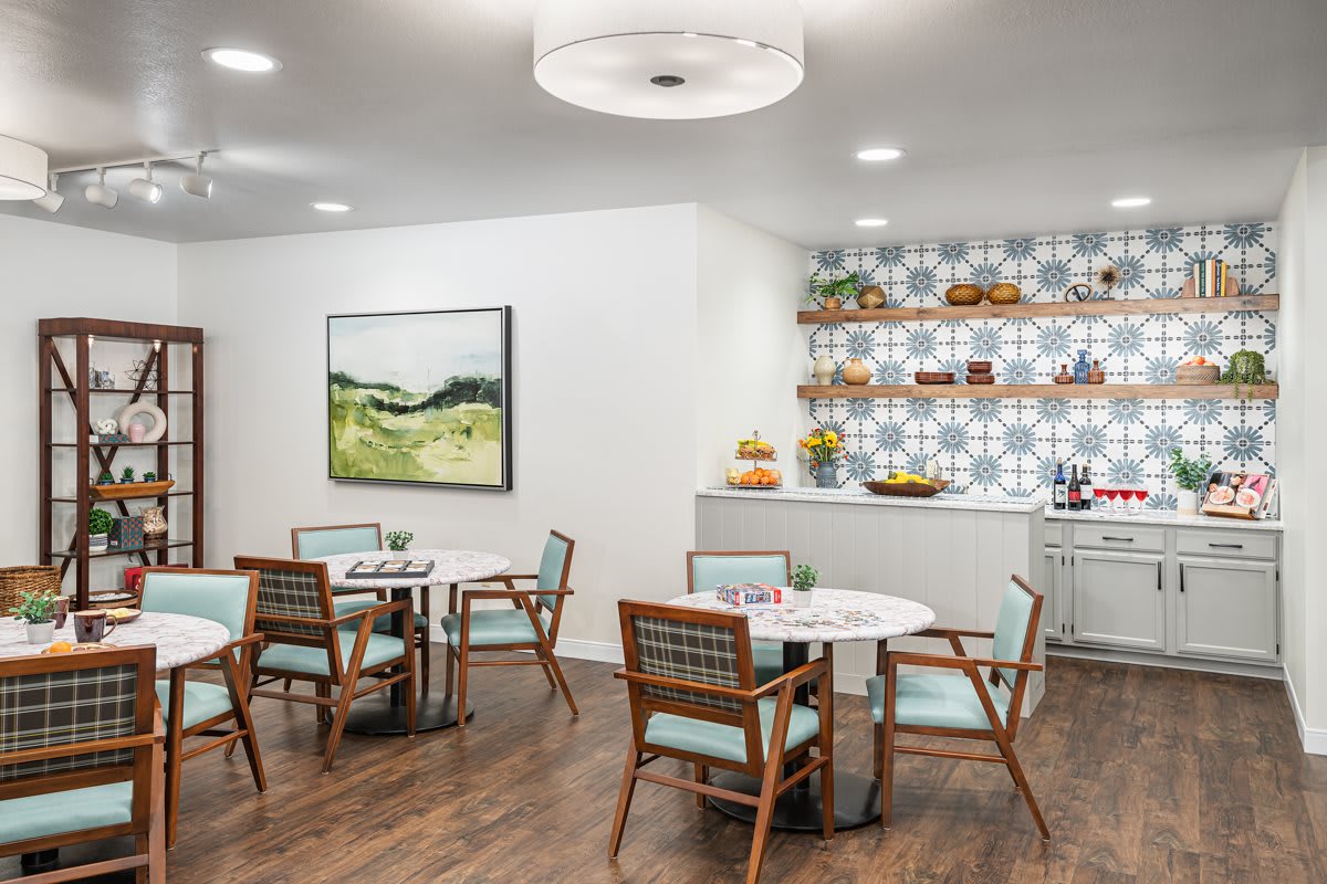 A modern dining area with stylish furniture and decorative shelves.