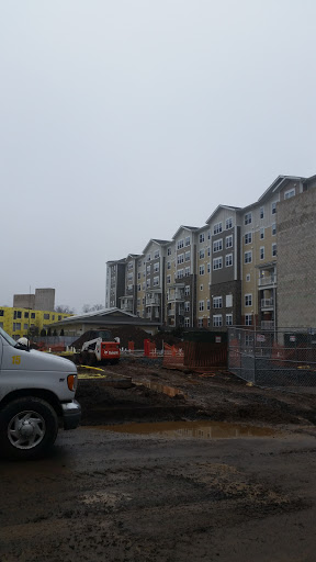 A view of an apartment complex under construction on a cloudy day.