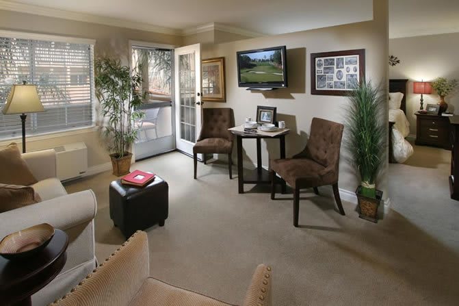 Cozy living room with comfortable seating and a wall-mounted TV.