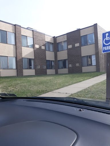 A view of a multi-unit residential building with handicap parking signage.