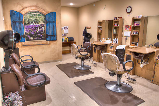 Interior of a hair salon featuring styling chairs and mirrors.