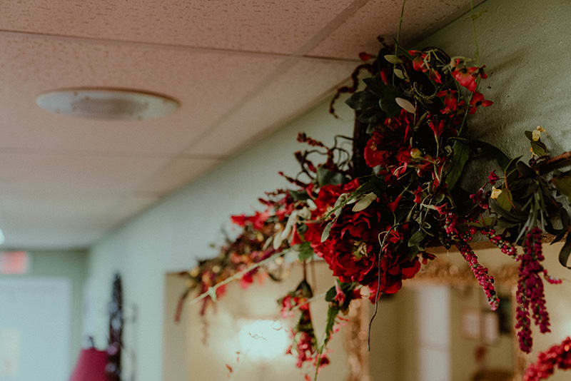 A decorative arrangement of artificial flowers hangs from the ceiling, adding a touch of color to the interior space.