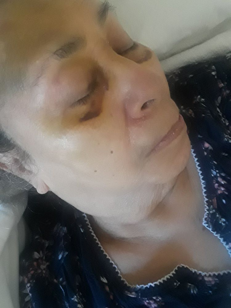 A close-up of a person sleeping indoors.