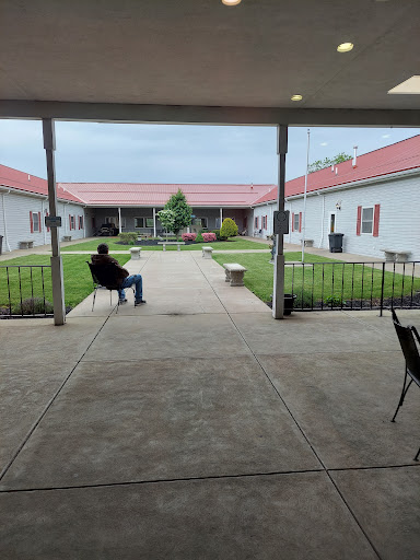 A serene courtyard view with a person sitting and enjoying the open space.
