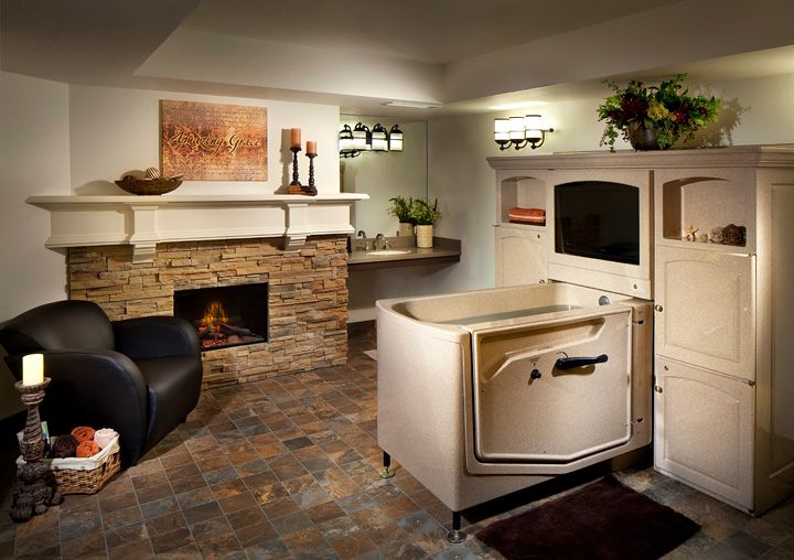 A luxurious bathroom with a walk-in bathtub and a cozy fireplace.