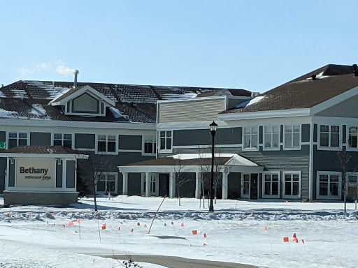A modern building surrounded by snow in a winter landscape.
