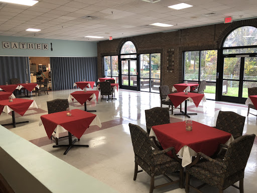 A cozy dining area featuring red-tablecloth-covered tables, ideal for casual meals.