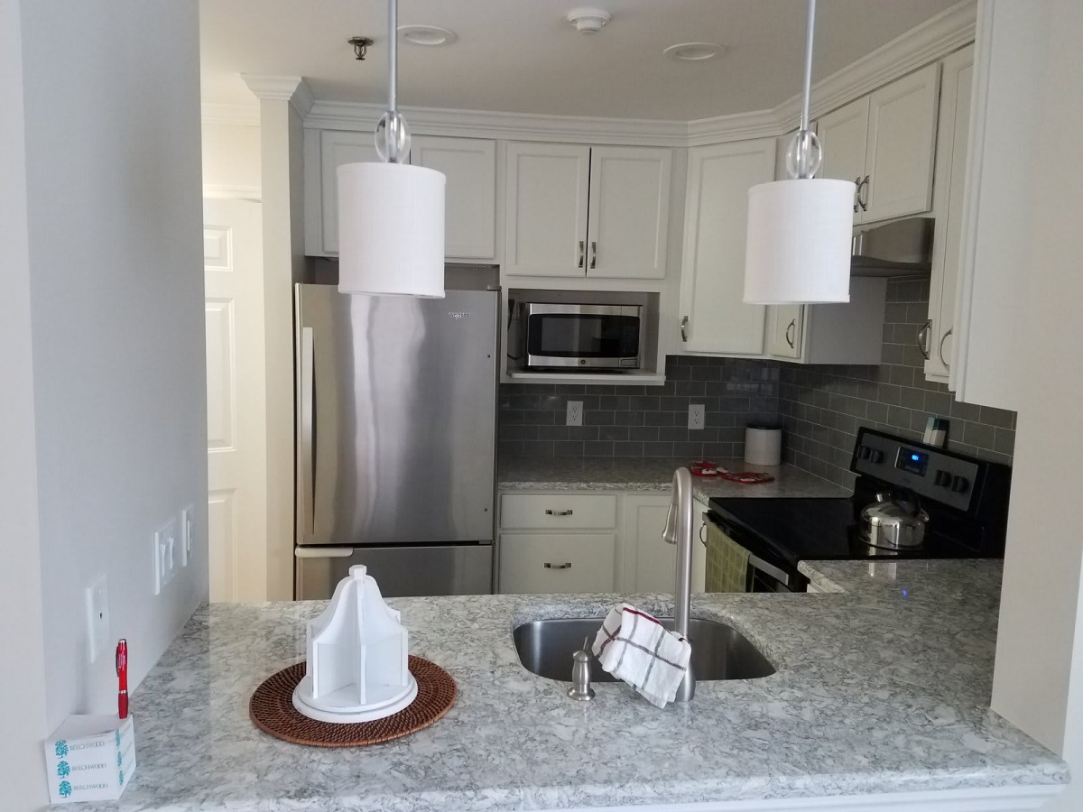 A modern kitchen with stainless steel appliances and granite countertops.
