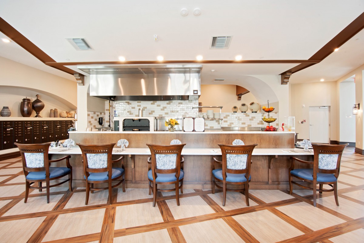 A modern kitchen with bar seating and stylish wooden accents.