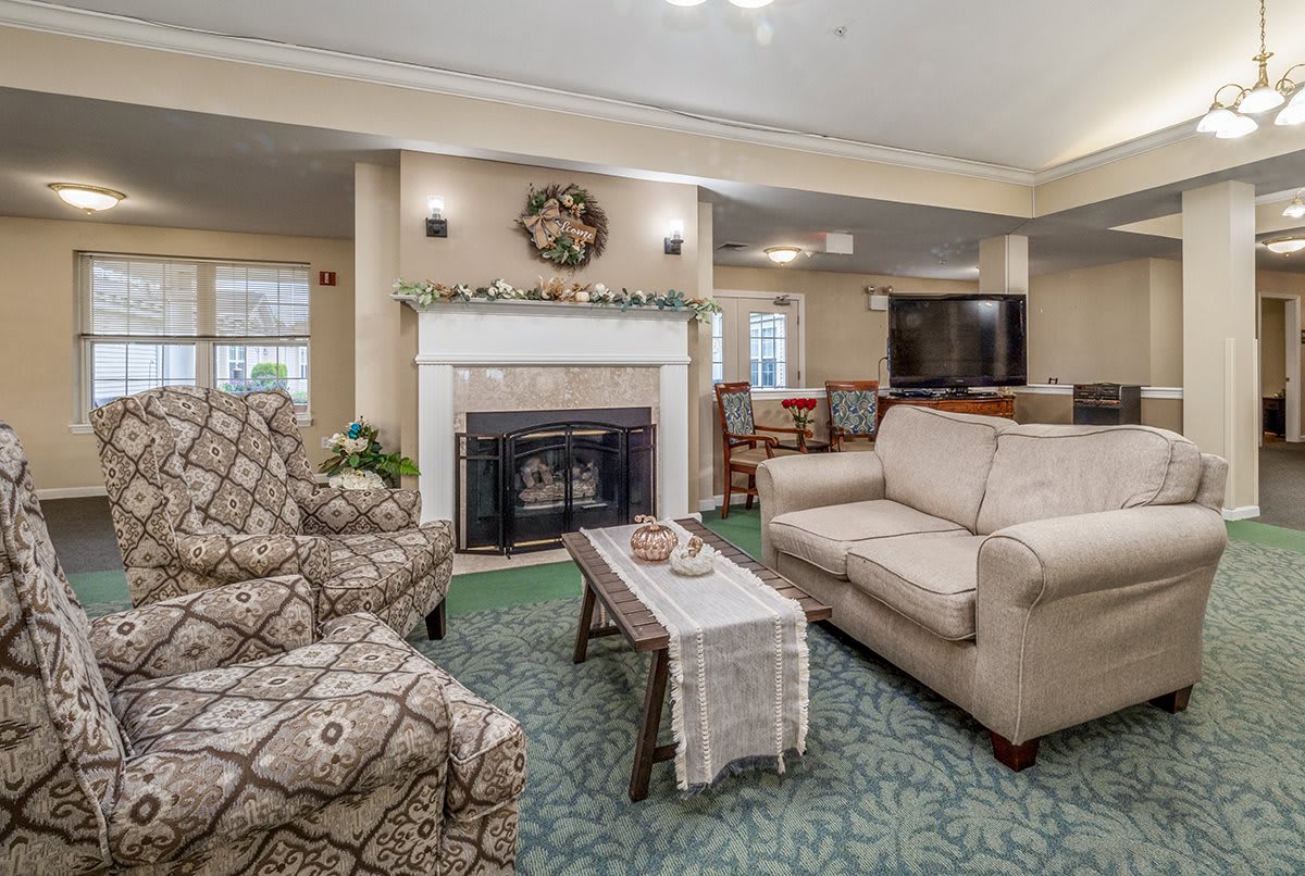 A cozy living room featuring comfortable furniture, a fireplace, and elegant decor.