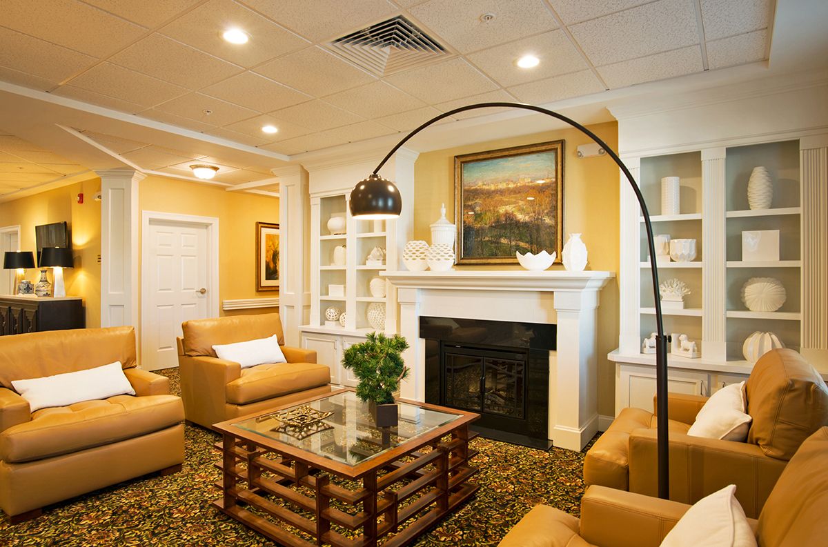 A cozy living room with a fireplace, comfortable sofas, a stylish coffee table, and elegant decor.