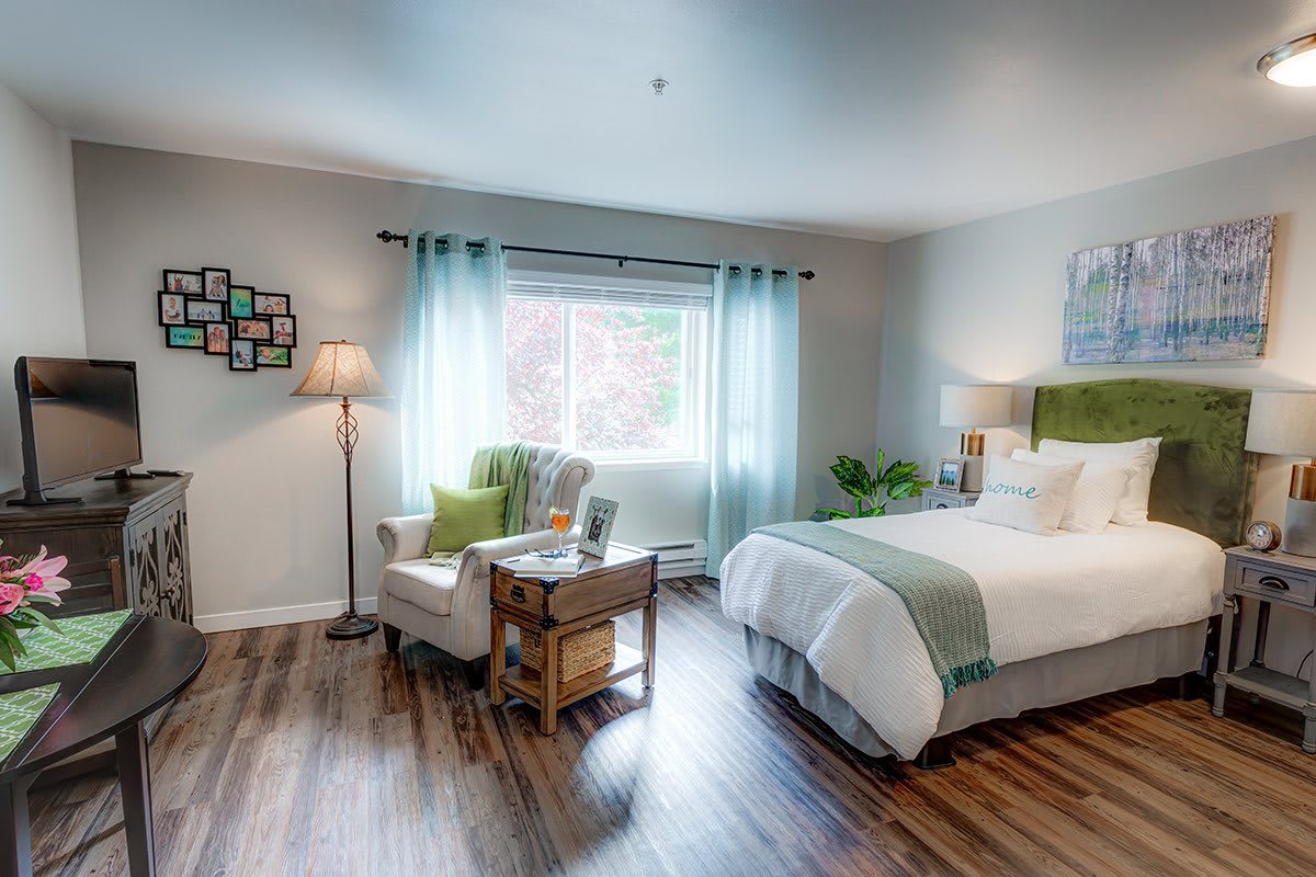 A cozy bedroom with stylish decor and ample natural light.